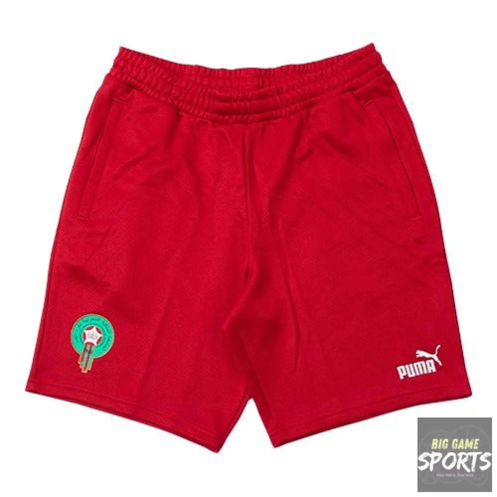 Red Puma athletic shorts with an elastic waistband, featuring a Morocco national team crest on the left leg and a white Puma logo on the right leg, displayed on a solid white background.