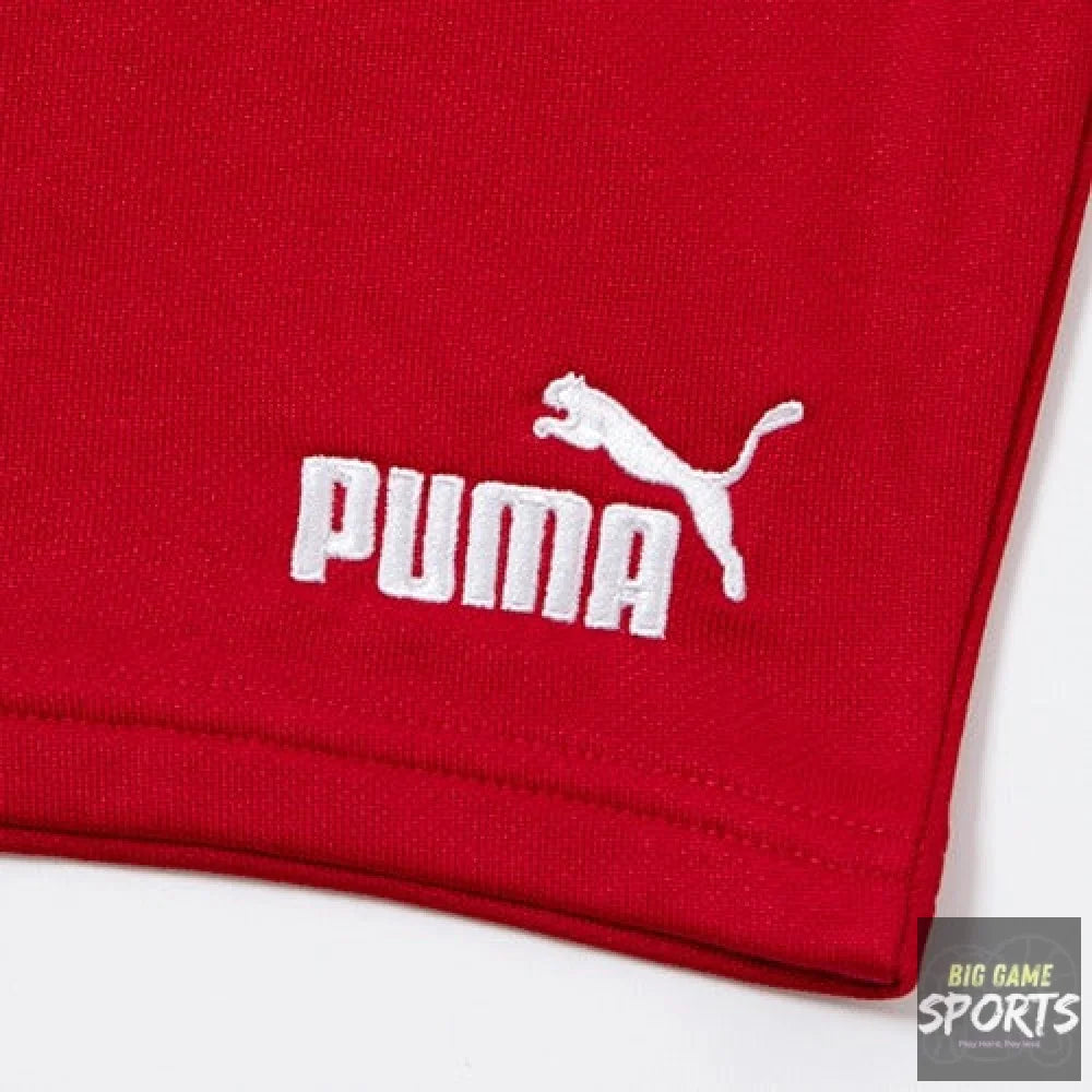 Close-up of a red Puma garment corner with a white embroidered Puma logo and leaping cat on a white background.
