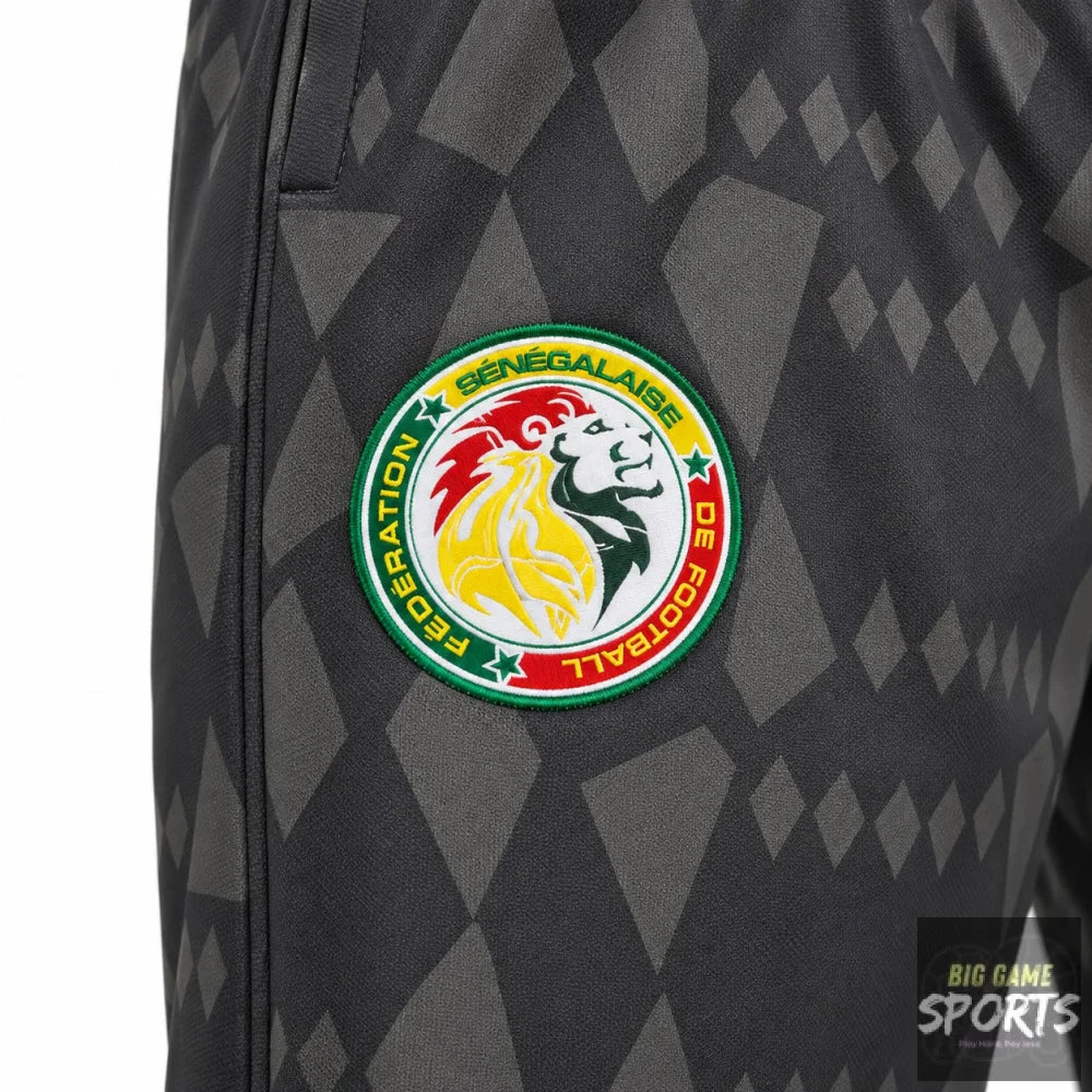 Close-up of a dark gray patterned soccer jersey with a circular Senegal Football Federation crest on the upper chest.
