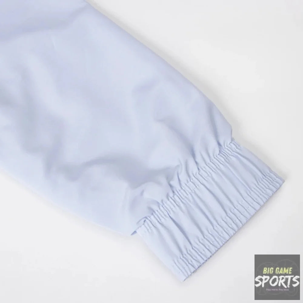 Close-up of a light blue elasticized cuff on a garment, shown against a plain white background.