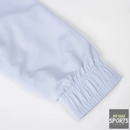 Close-up of a light blue elasticized cuff on a garment, shown against a plain white background.