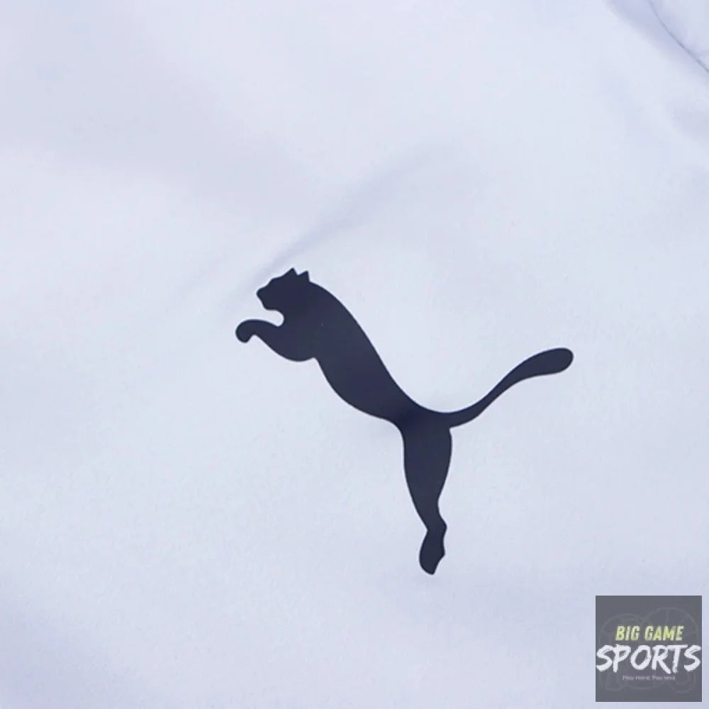 A close-up of a white fabric surface featuring the black Puma leaping cat logo.