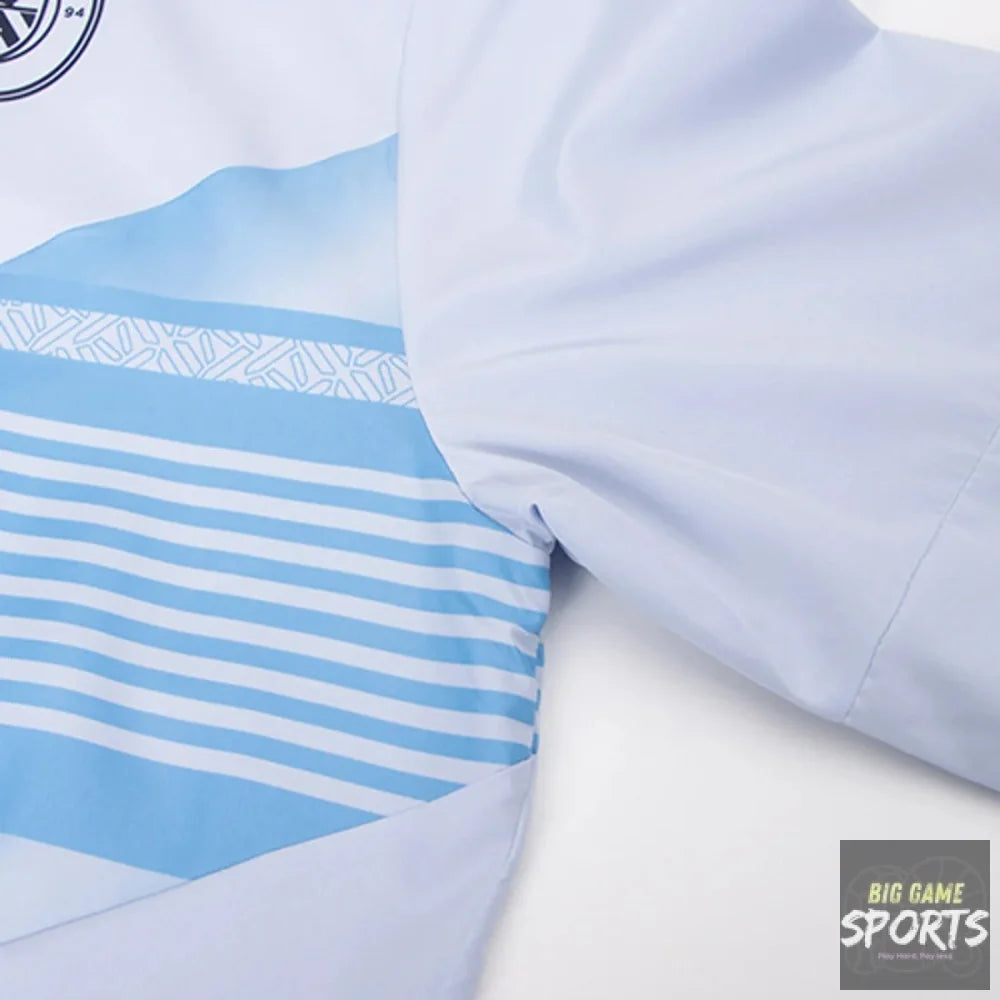 Close-up of a light blue and white athletic jersey showing the sleeve, shoulder, and a striped patterned panel.