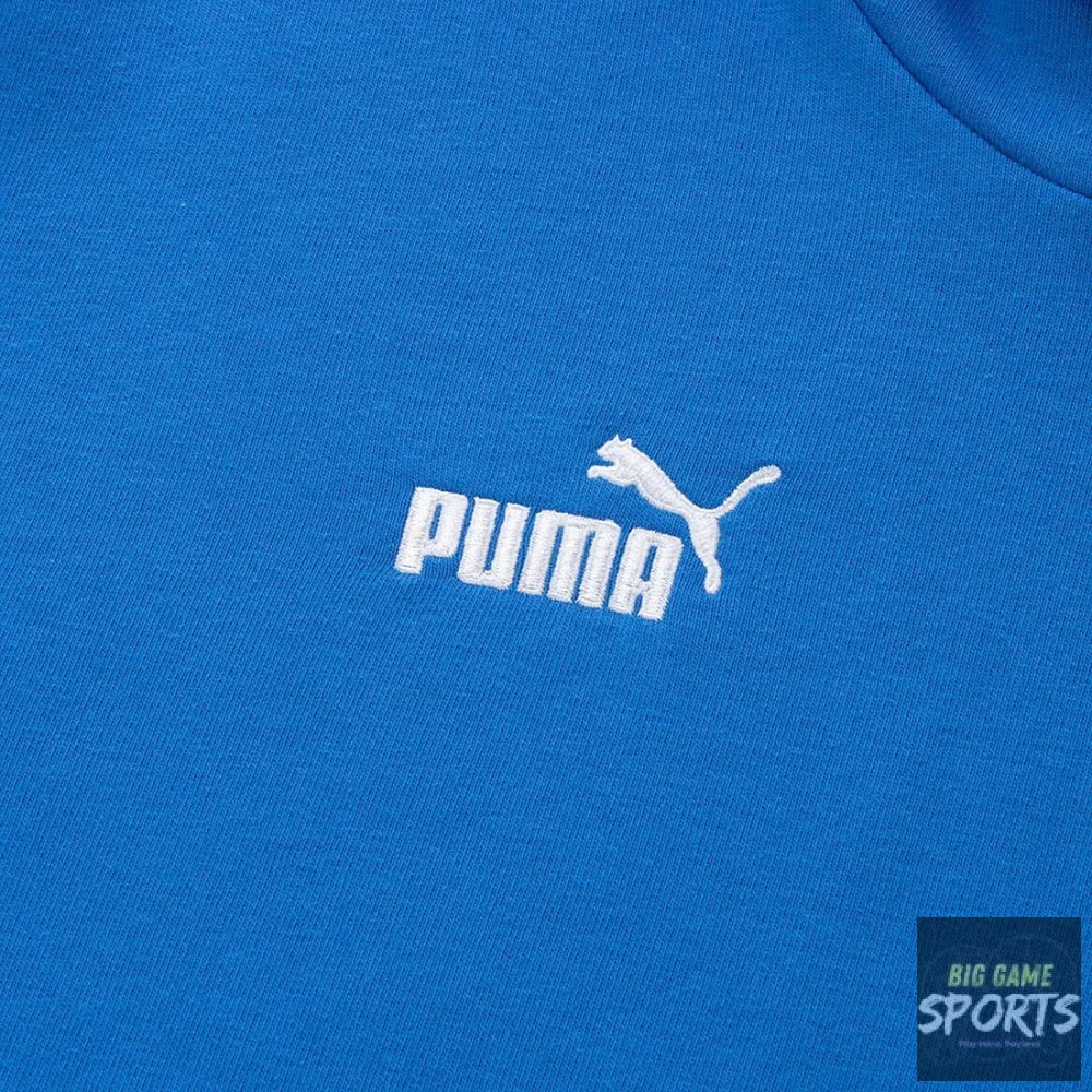 A close-up of a bright blue Puma sweatshirt showing the white embroidered Puma logo and leaping cat emblem on the chest.
