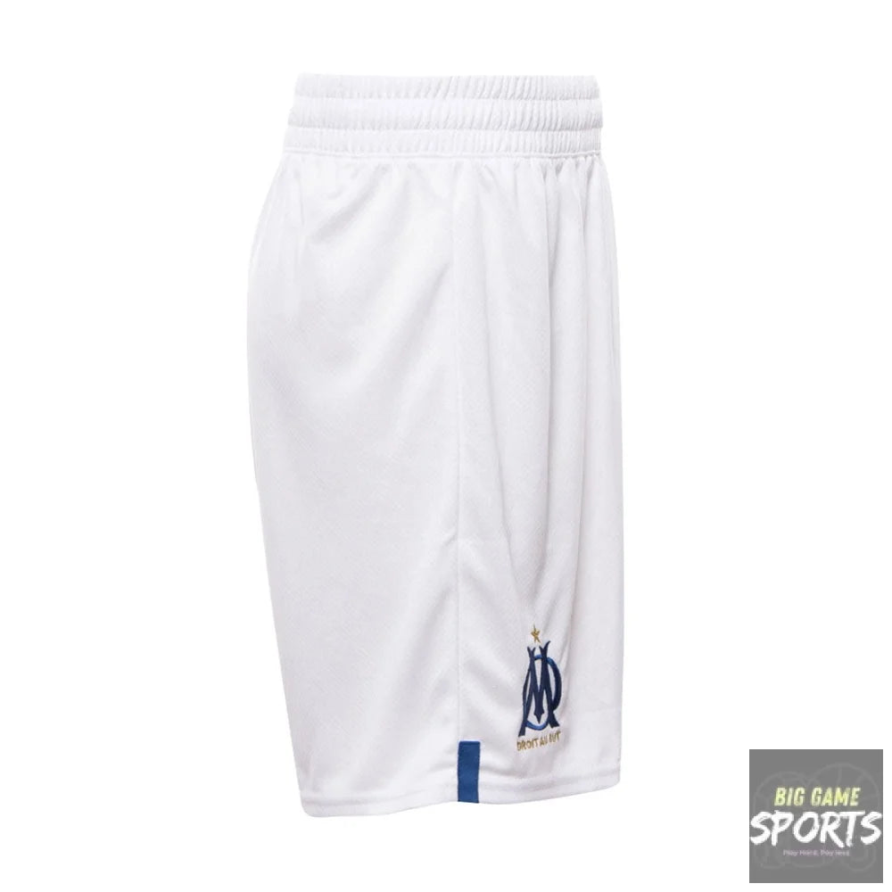 White athletic shorts with an elastic waistband, featuring the Olympique de Marseille logo in navy blue and gold on the lower left leg, and a small navy blue tab on the lower right hem.