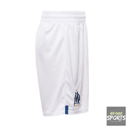 White athletic shorts with an elastic waistband, featuring the Olympique de Marseille logo in navy blue and gold on the lower left leg, and a small navy blue tab on the lower right hem.