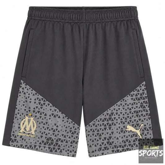 Dark gray athletic shorts featuring a geometric patterned lower panel in gray, with a gold Olympique de Marseille crest on the left leg and a gold Puma logo on the right leg.