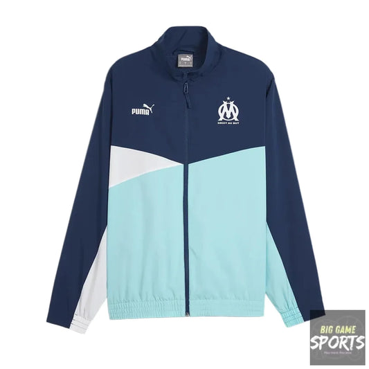A Puma track jacket in navy blue, light blue, and white, featuring the Olympique de Marseille club crest on the left chest and a white Puma logo on the right chest.