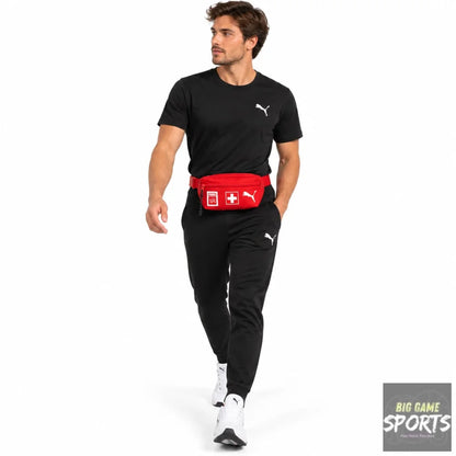 A man wearing a black Puma t-shirt, black sweatpants, and a red Puma Swiss Army fanny pack waist bag, walking against a white background.